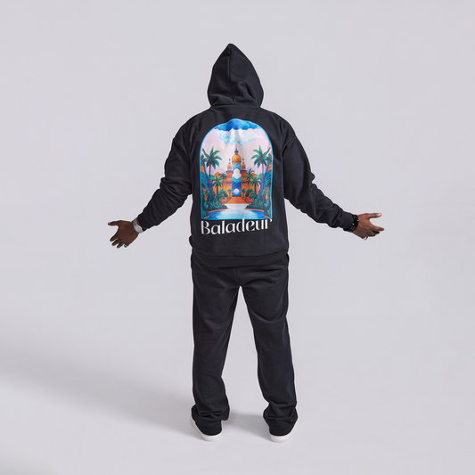 Black hoodie with a colorful graphic on the back and matching pants, on a white background