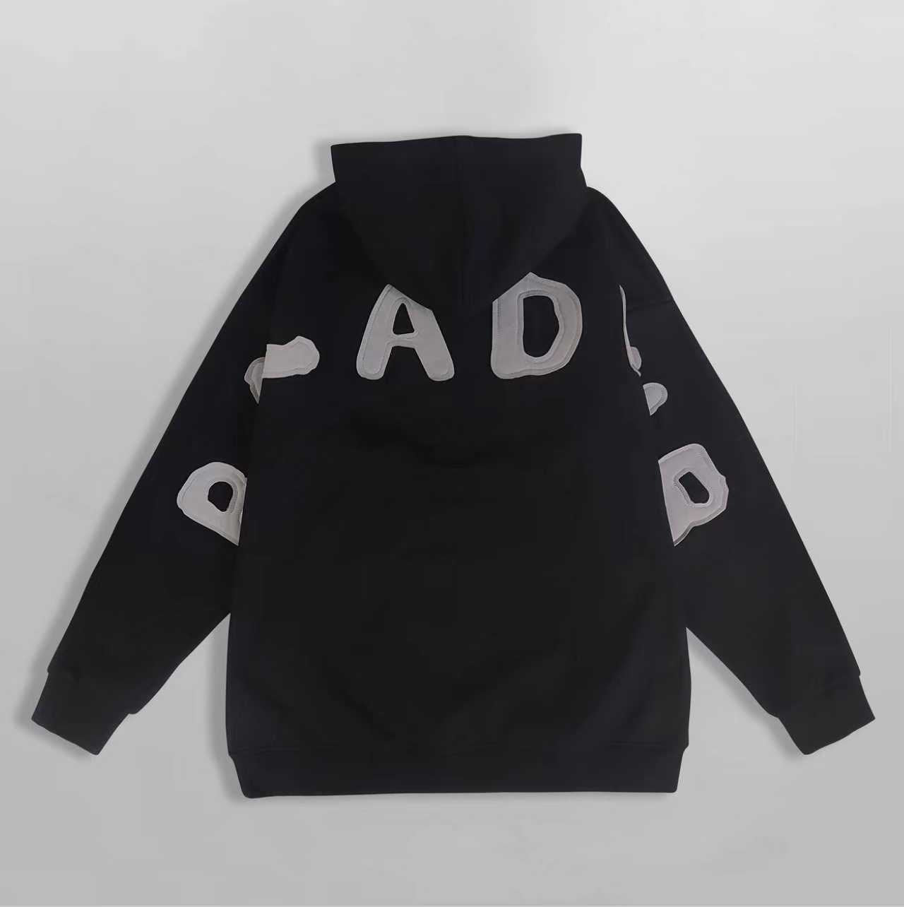 Black hoodie with white branding on a light gray background showing the logo of the brand Baladeur
