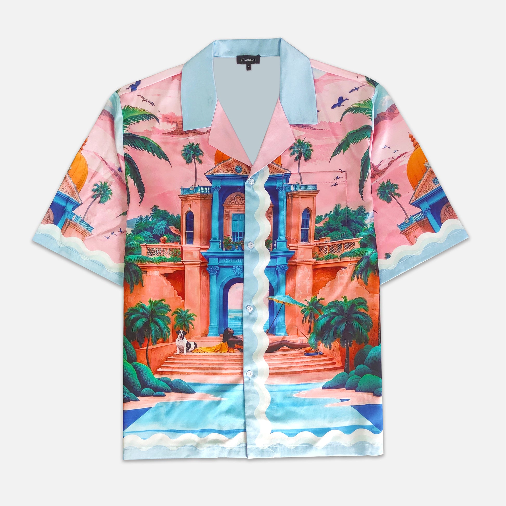 Colorful shirt with a tropical design featuring architecture and palm trees on a white background